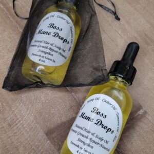 Two bottles of Boss Mane Drops hair oil.