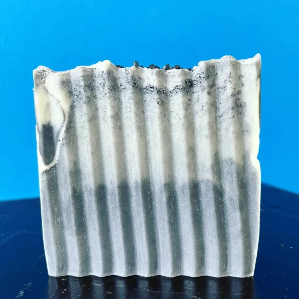 Black and white striped handmade soap bar.