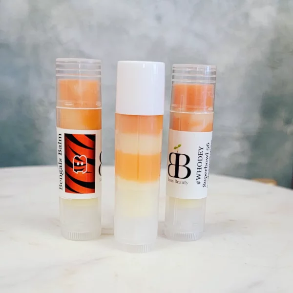 Three colorful lip balms in tubes.