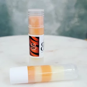 Orange and white striped lip balm tube.