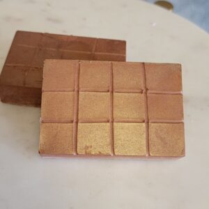 Two bars of gold soap on counter.