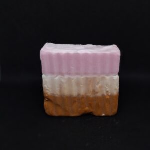 Layered pink, white, and brown soap bar.