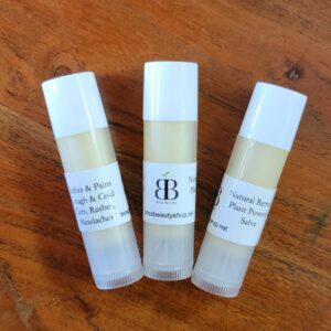 Three white tubes of natural salve.