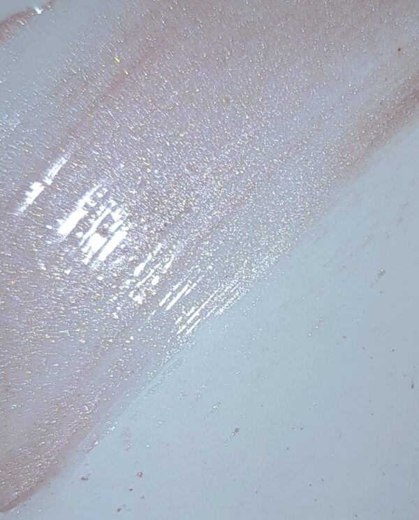 White surface with pink glitter overlay.