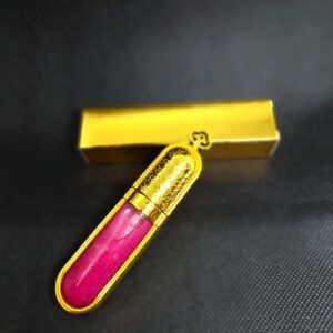 Pink lip gloss in gold tube.