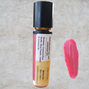 Lip balm with pink swatch on background.
