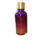 Purple and gold glitter serum bottle.