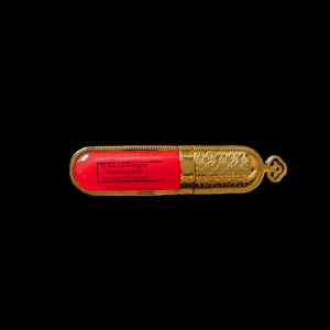 Gold and red lip plumping oil bottle.